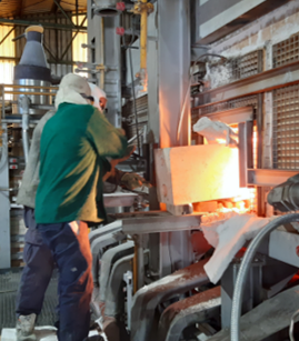 Person working the glass furnace